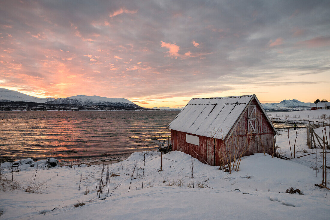 Typical fisherman house in front of fjord of Tromso, Troms County, Norway, Europe