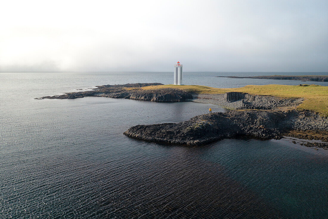 aerial view taken by drone of Kálfshamarsvik lighthouse, Nordurland, Iceland, Europe