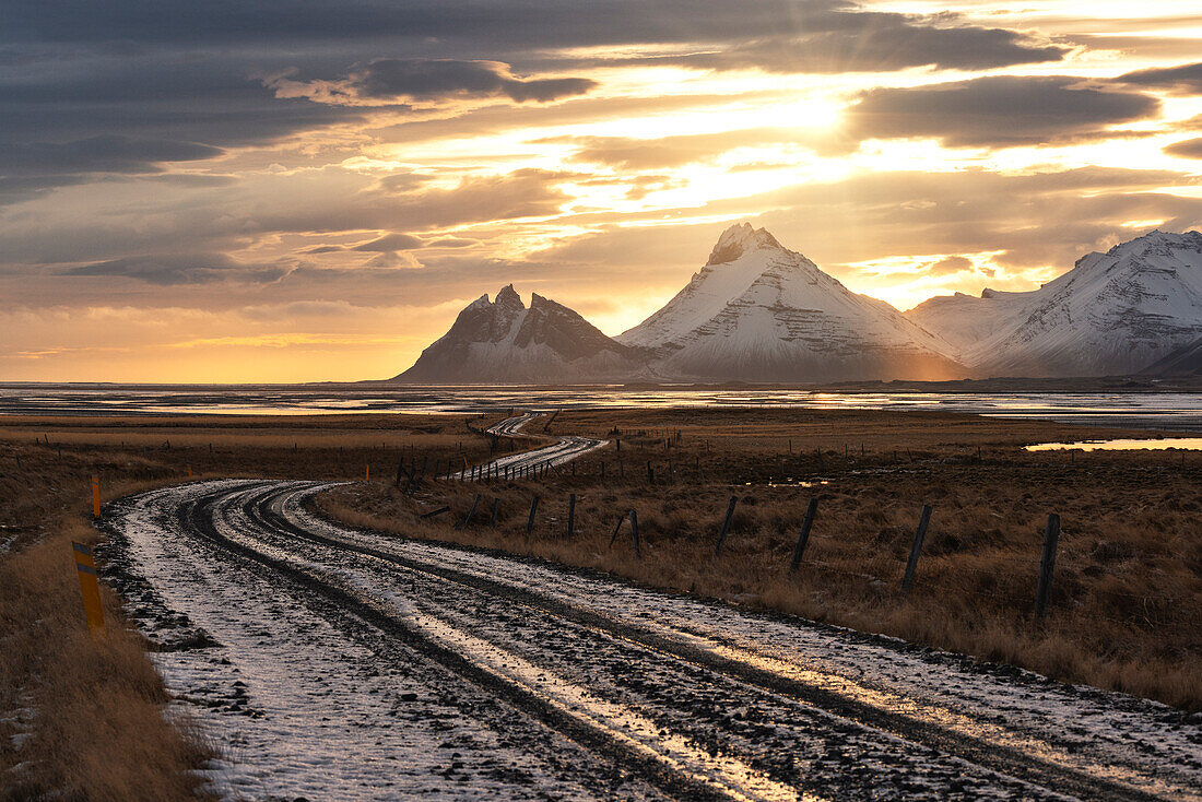 An off road illuminated by an warm sunset, Vestrahorn mountain, Austurland, Southern Iceland, Europe