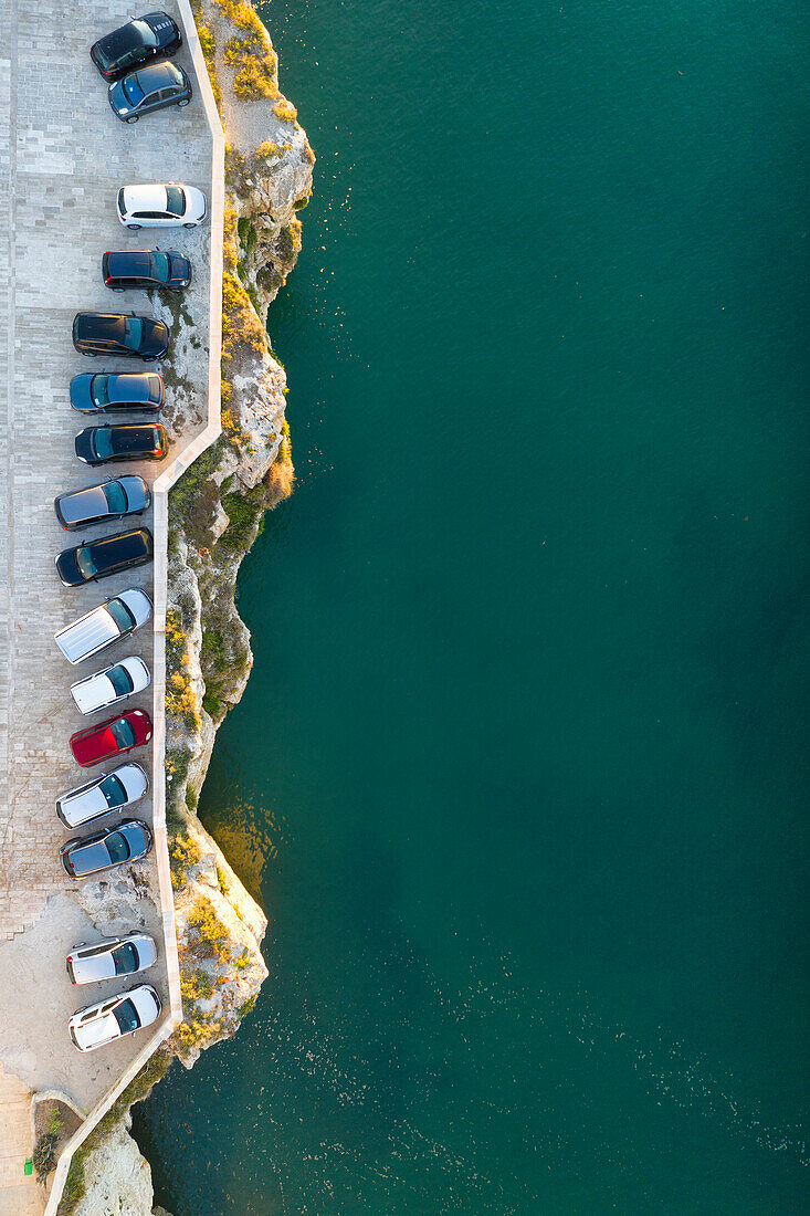 vertical aerial view of the historic center of Vieste, taken during a summer sunrise, municipality of Vieste, Foggia province, Apulia district, Italy, Europe
