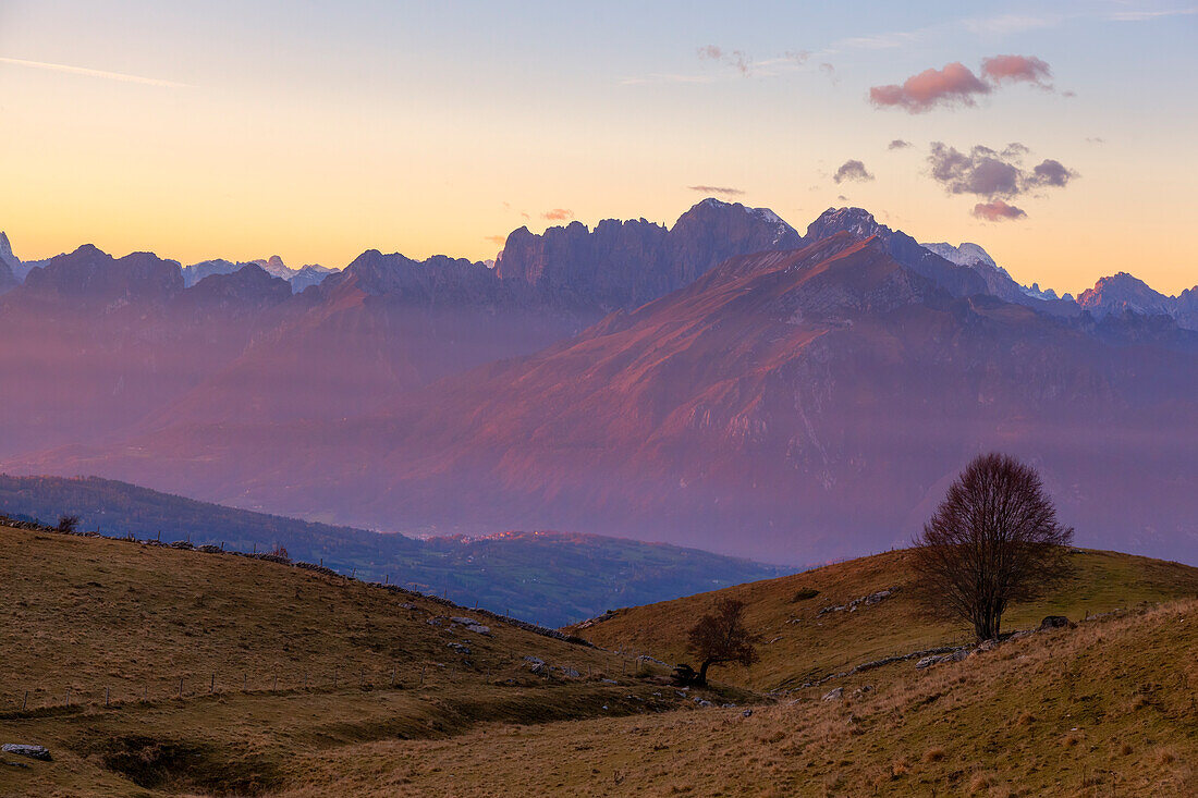 A autumn sunset on Schiara group seen from the pastures of Mezzomiglio Alm, Alpago, Belluno province, Veneto, Italy.