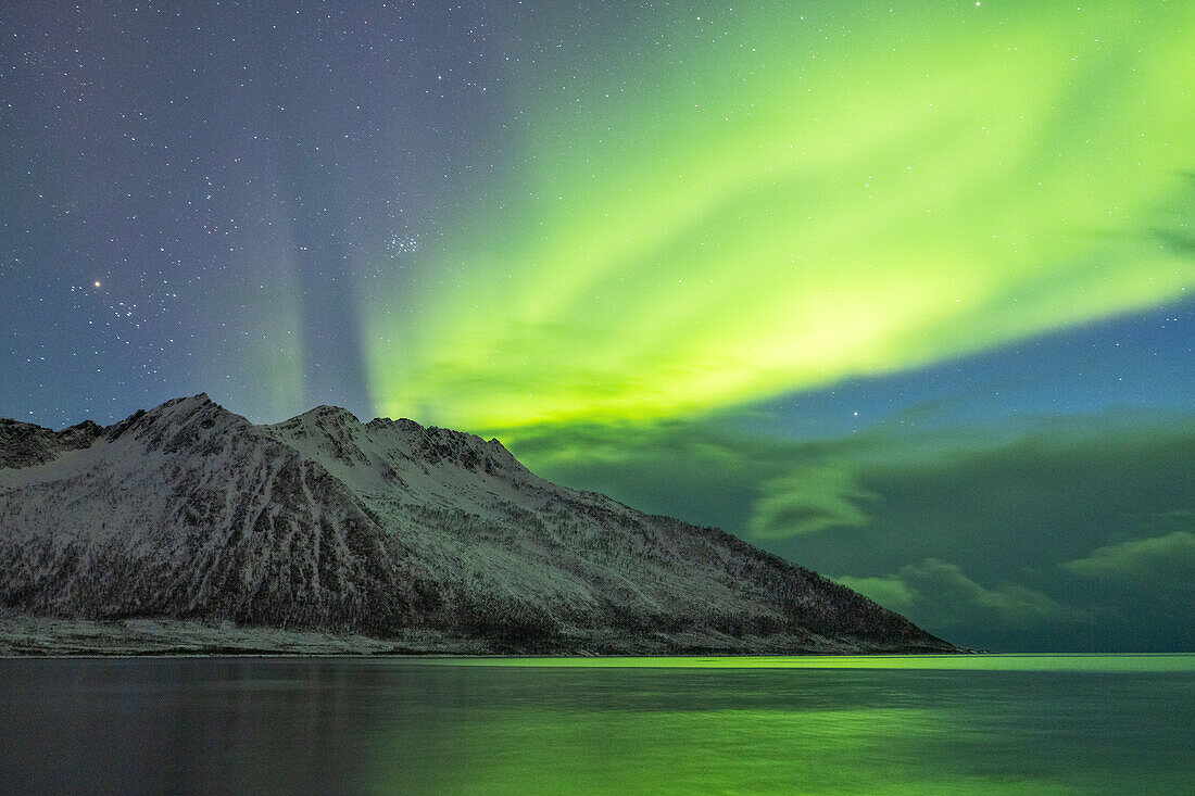 the Northen Lights over the peaks near to Gryllefjord, Senja, Norway, Europe