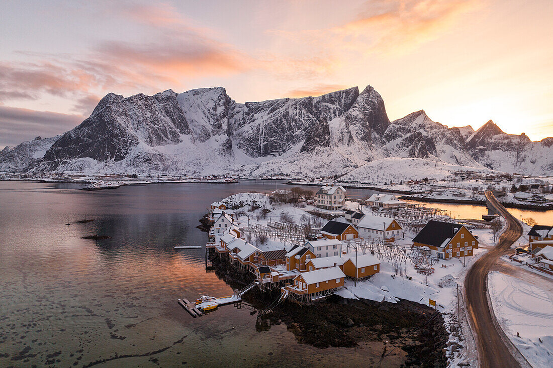 Winter sunset over Sakrisoy village with mountain peak covered with snow, Lofoten Islands, Norway, Europe