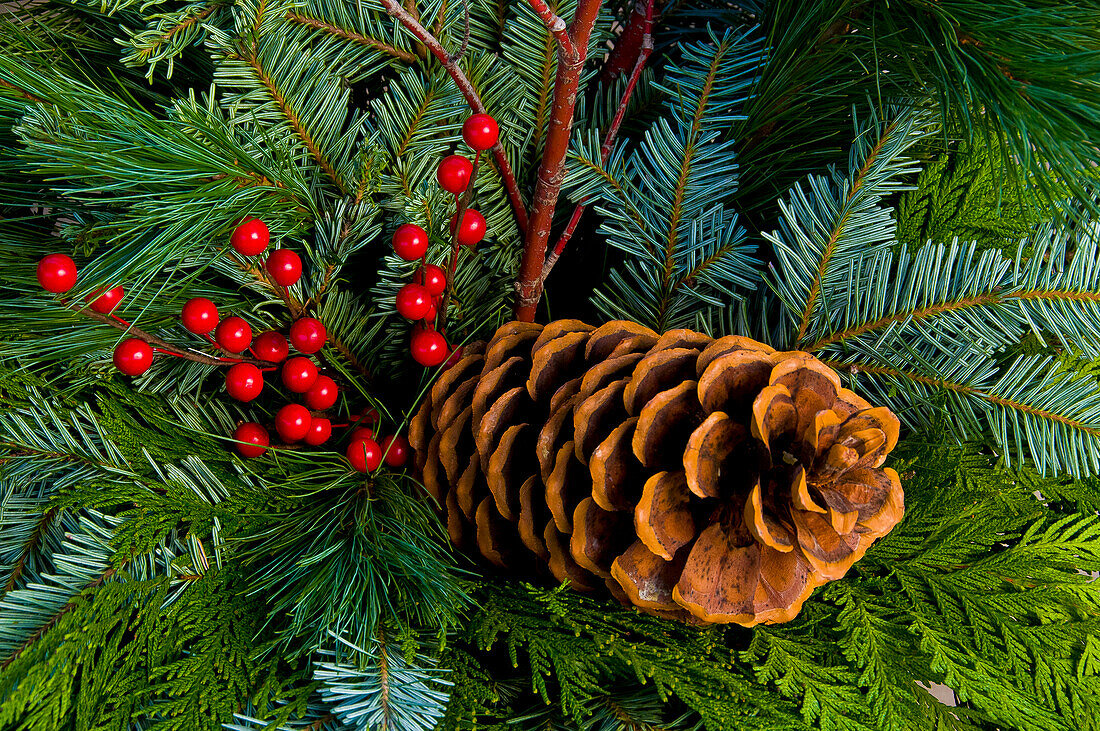 Christmas wreath with pine cone and berries.