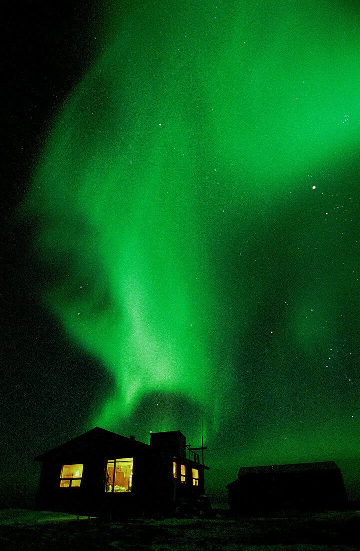 Aurora Borealis Northern Lights over tundra lodge Hudson Bay near Churchill, Manitoba, sub-arctic, Northern Canada