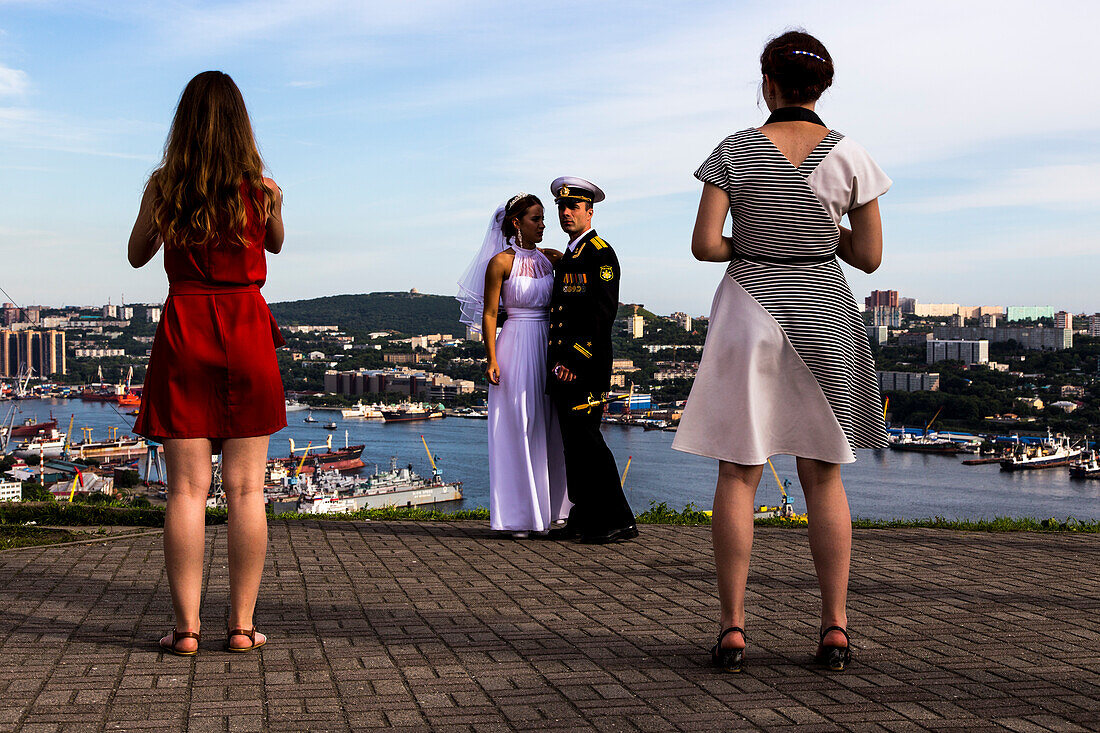 Bride and groom with the harbour and the Golden Horn Bay in Vladivostok