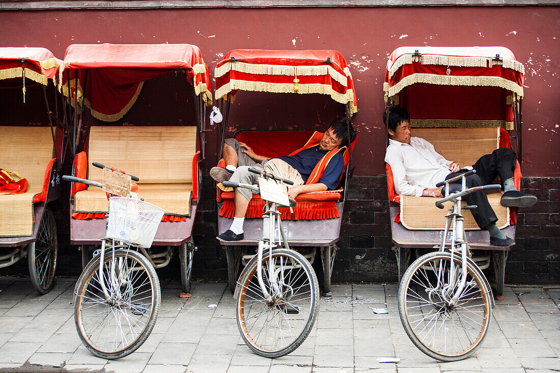 Cycle rickshaw drivers resting