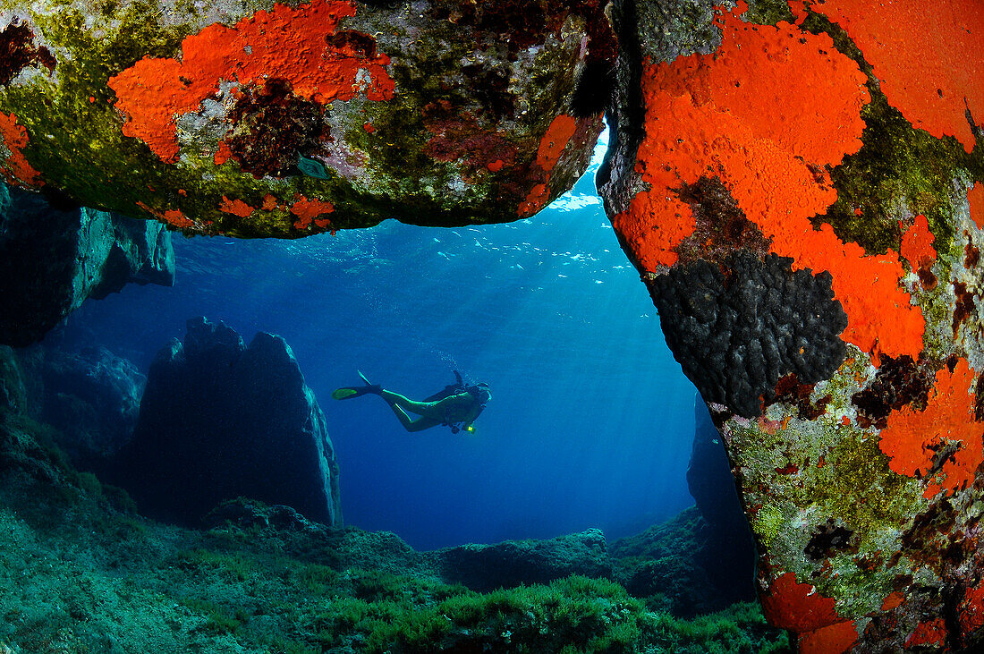 Diver in a nice cave of Capraia island, Tuscan archipelago.