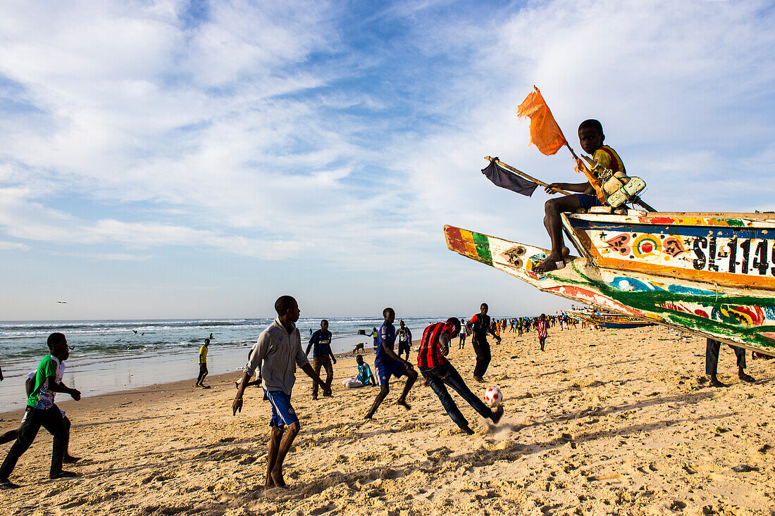 Boys playing football on the beach in Saint-Louis