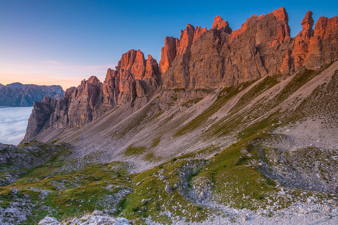 Sunrise on the mountain ridge on the south-east side of the valley at Marchi Granzotto alpine hut, in Val Meluzzo, Pordenone, Friuli Venezia Giulia, Italy.