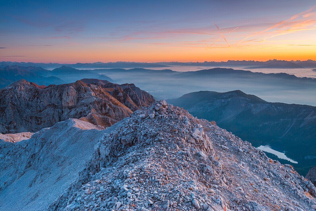 Colorful sky at sunrise as seen from a summit in the mountains of the Brenta Dolomites, above lake Tovel in Trento province, Trentino Alto Adige region, Italy.