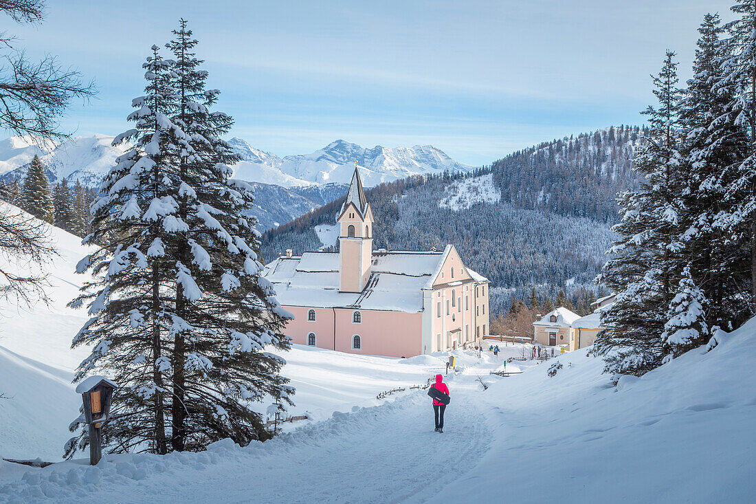 A woman walking to the pilgrimage Church of Maria Waldrast, Mühlbach, Innsbruck Land, Tyrol, Austria, Europe
