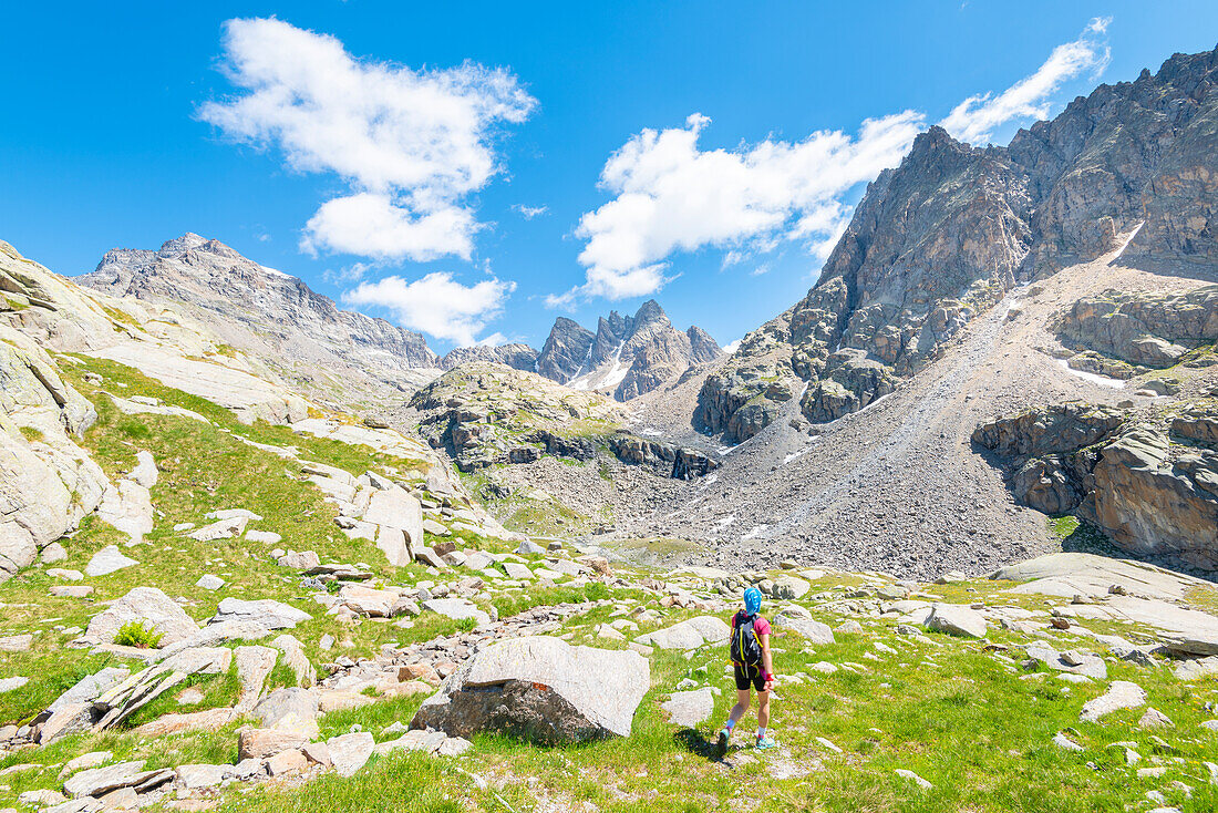 Hiker in the Vallone di Noaschetta, Valle dell Orco, Gran Paradiso National Park, Province of Turin, italian alps, Piedmont, Italy