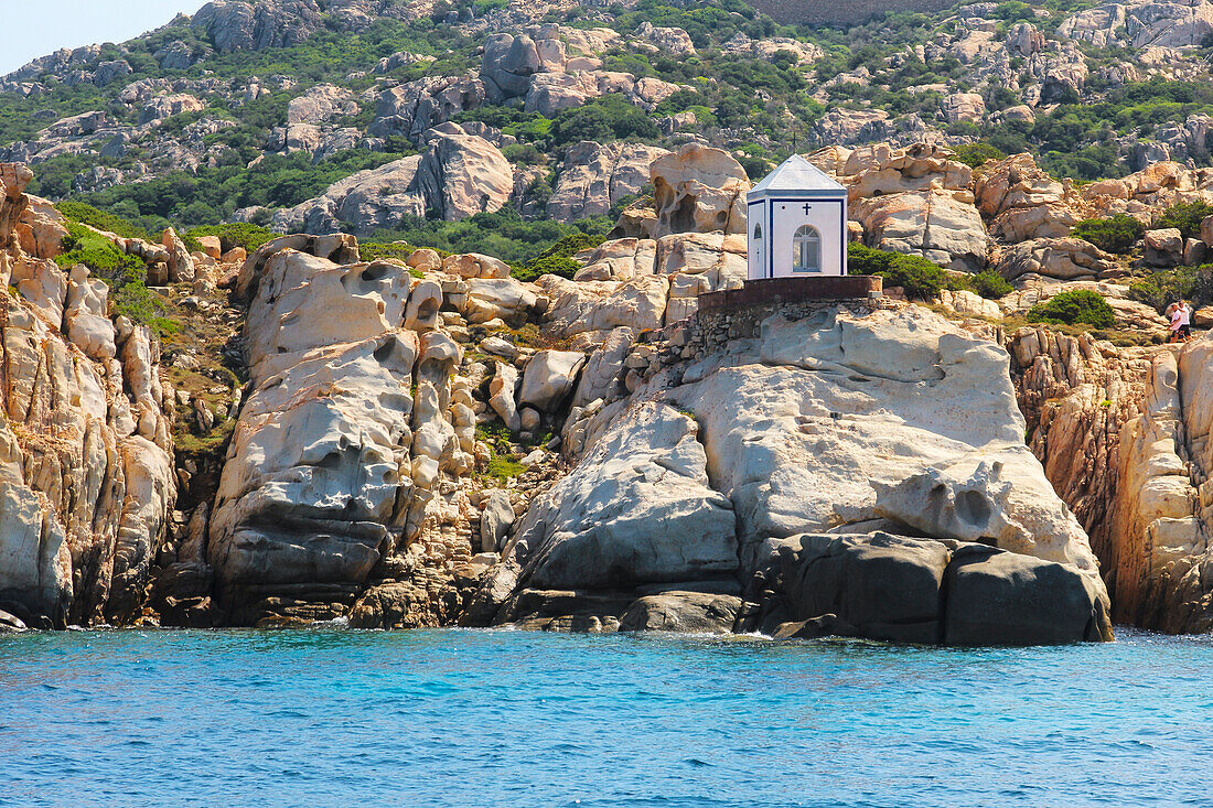 View from the boat on the Cappella della Madonnetta in Cala Carlotto, La Maddalena island, Sassari province, Sardinia, Italy, Europe.