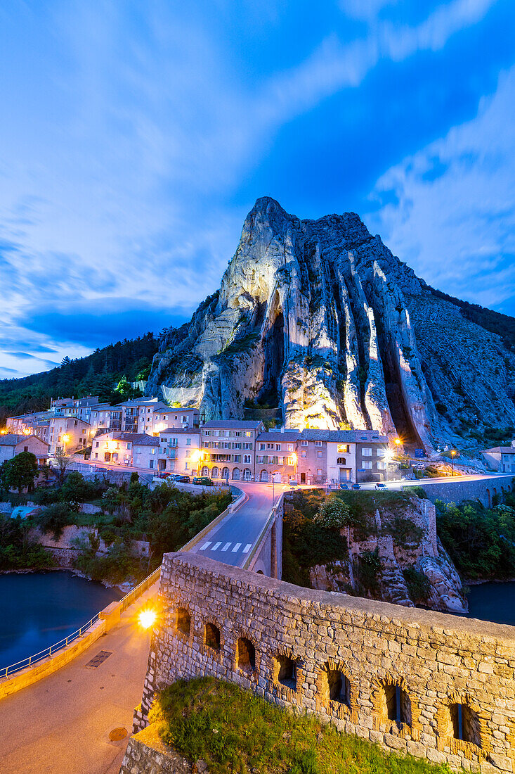 The road bridge of Sisteron by night with the rocher de la Baume in background. Sisteron, Durance valley, Provence, France, Europe.