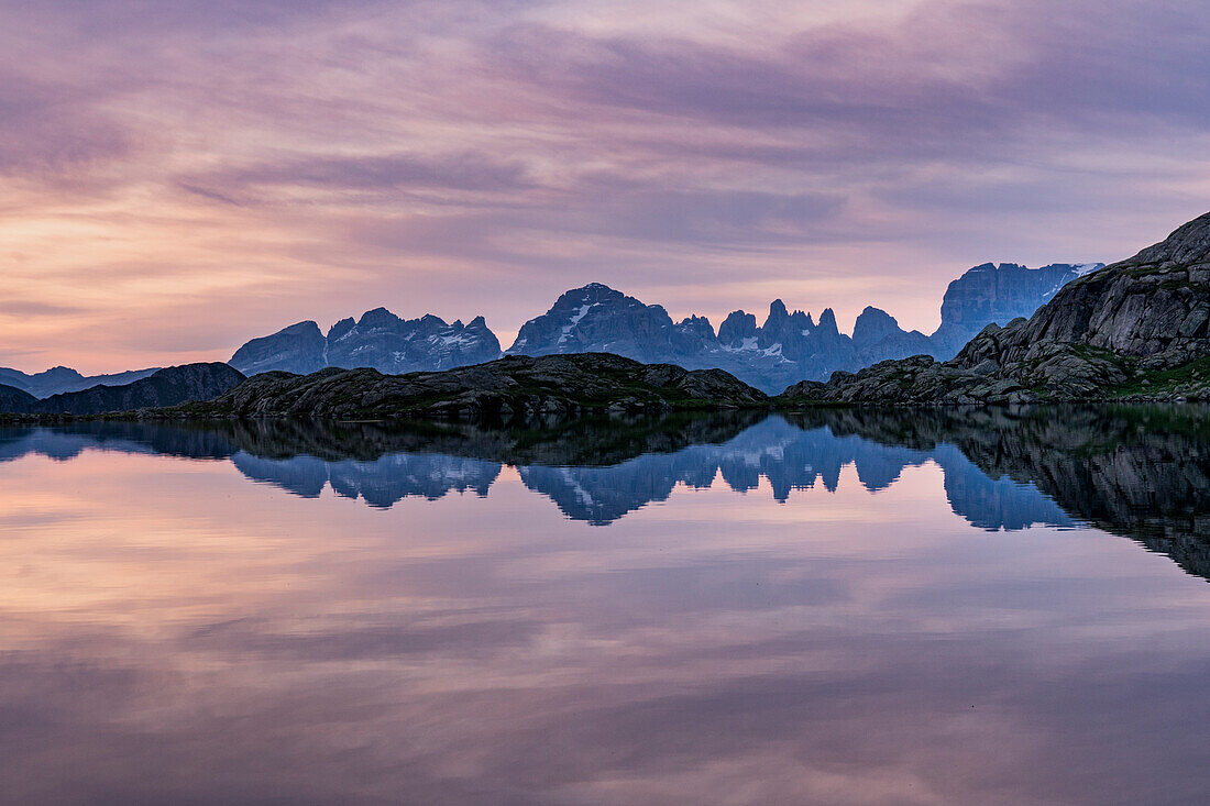 Brenta Dolomites reflected in the Black lake at sunset. Madonna di Campiglio, Nambrone valley, Trentino Alto Adige, Italy, Europe.