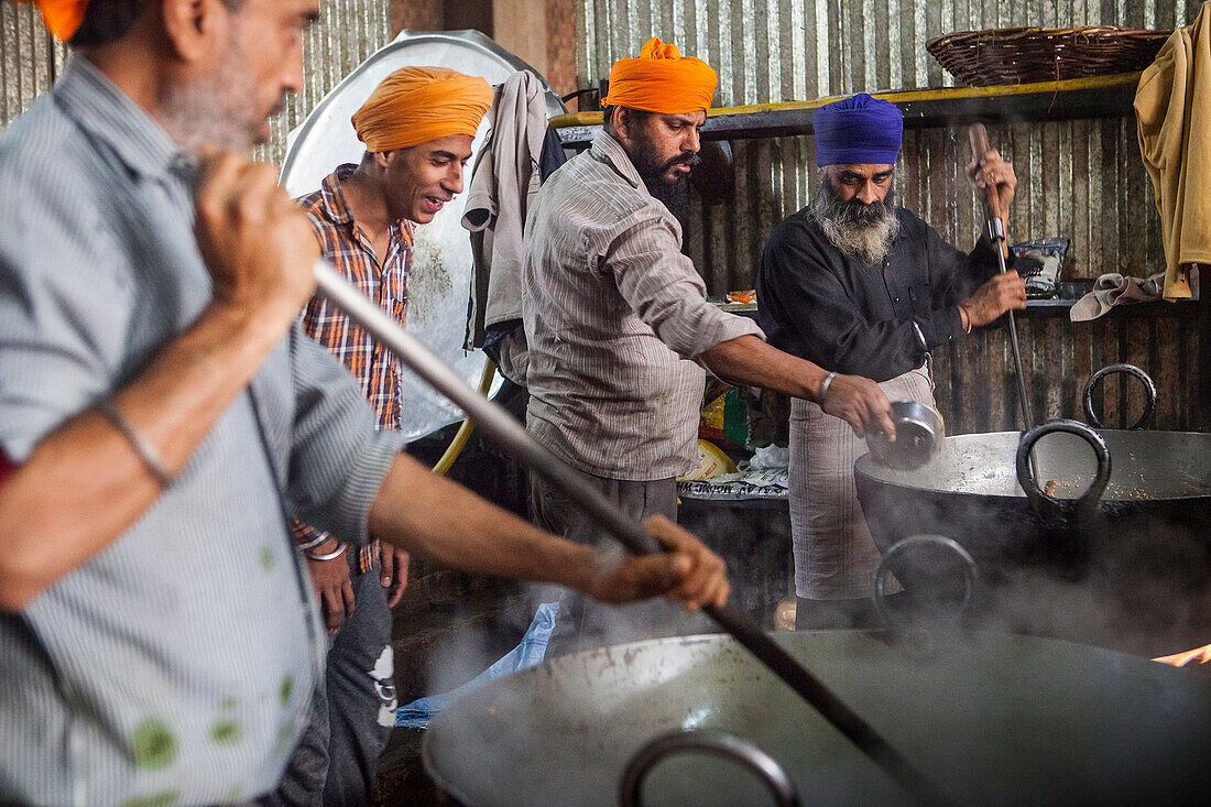 Volunteers cooking for the pilgrims who visit the Golden Temple, Each day they serve free food for 60,000 - 80,000 pilgrims, Golden temple, Amritsar, Punjab, India