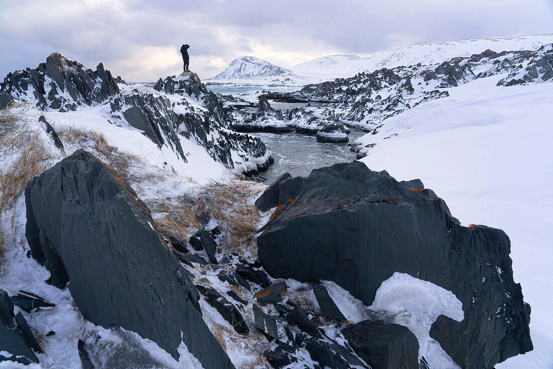 Europe, Norway, Finnmark, Sandfjorden, Hiker on the rocks