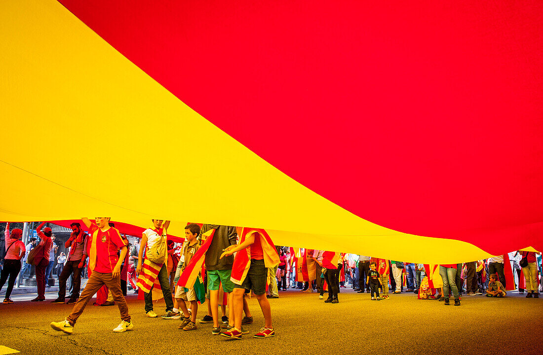 Anti-independence Catalan protestors carry Spanish flag during a demonstration for the unity of Spain on the occasion of the Spanish National Day at Passeig de Gracia, Barcelona on October 12, 2014, Spain