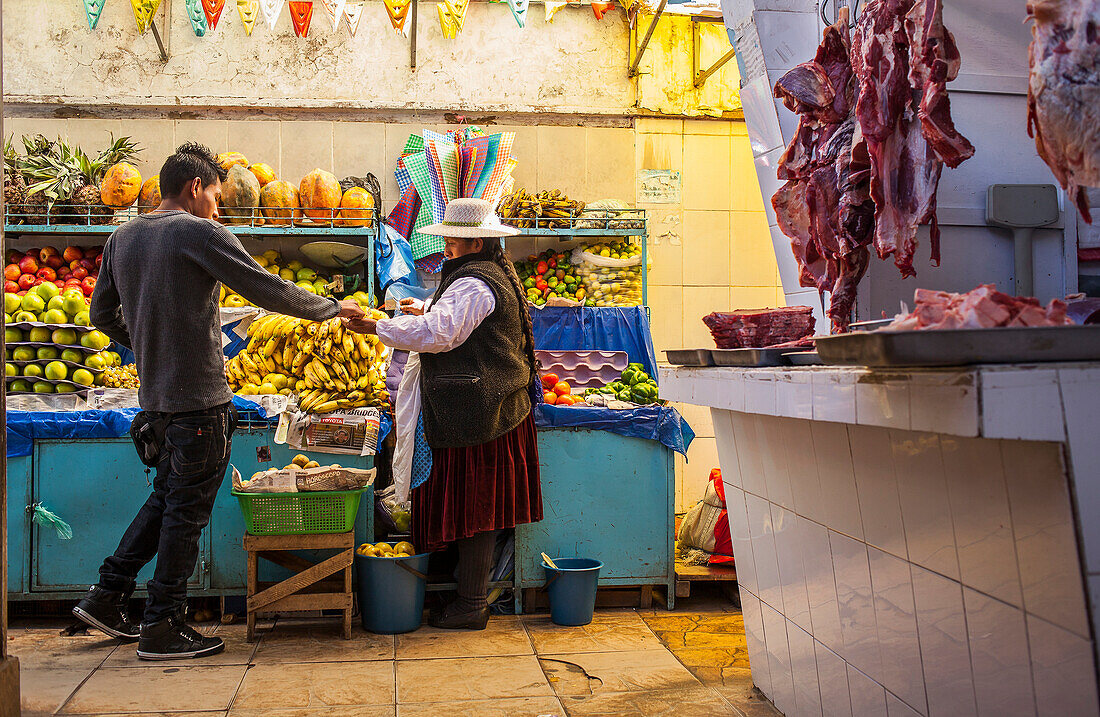 Seller and buyer, Market of Potosi, in calle Bolivar at calle Bustillos, Potosi, Bolivia