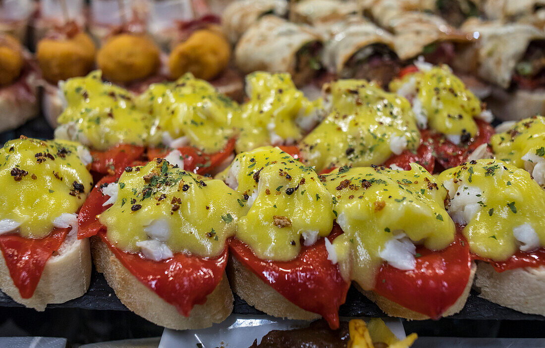 Pintxos, area of bars and restaurants, in La Ribera market, Bilbao, Spain