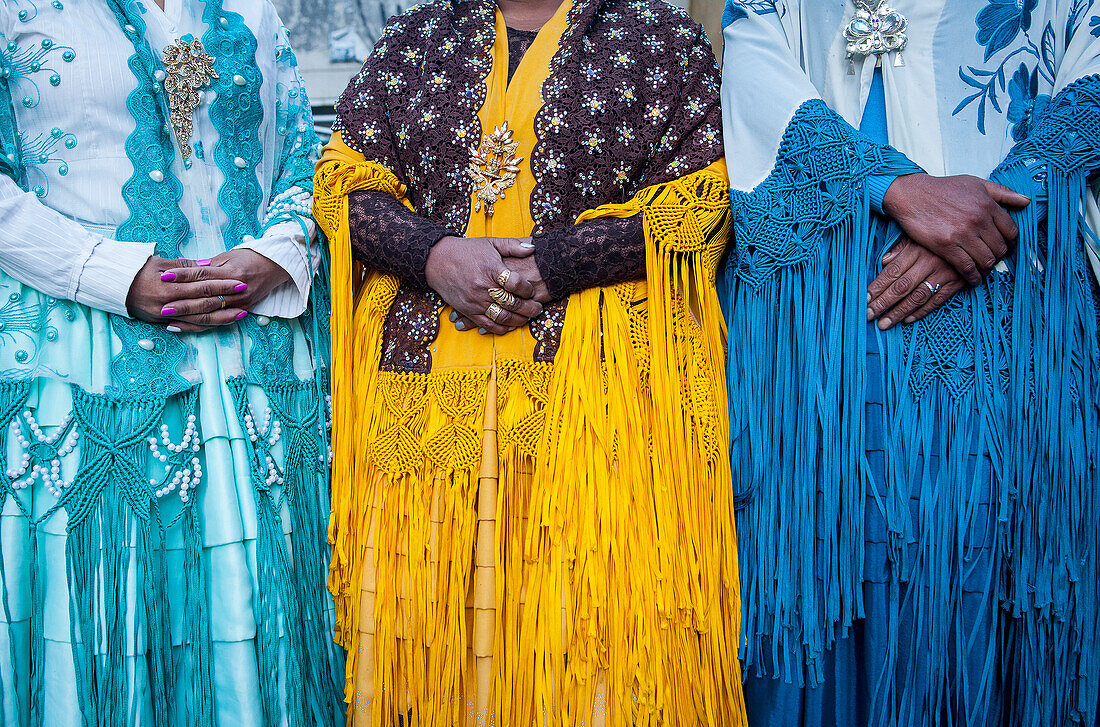 Detail of dresses and hands. At left Benita la Intocable , in the middle Angela la Folclorista, and at right Dina, cholitas females wrestlers, El Alto, La Paz, Bolivia