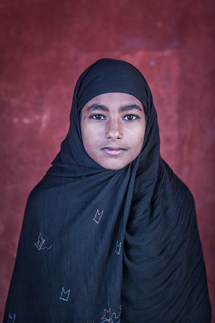 Portrait of a muslim girl, in Jama Masjid mosque, Delhi, India