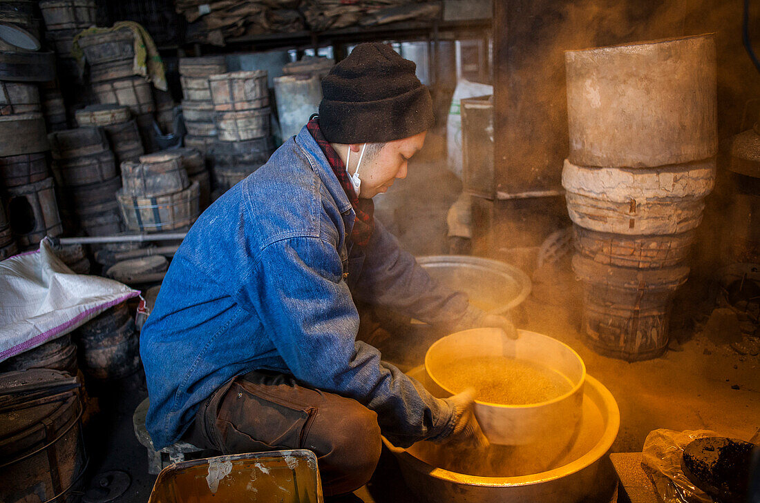 kohei ishimori is sifting sand to make mud, and build a molds to make a iron teapot or tetsubin, nanbu tekki,Workshop of Koizumi family,craftsmen since 1659, Morioka, Iwate Prefecture, Japan