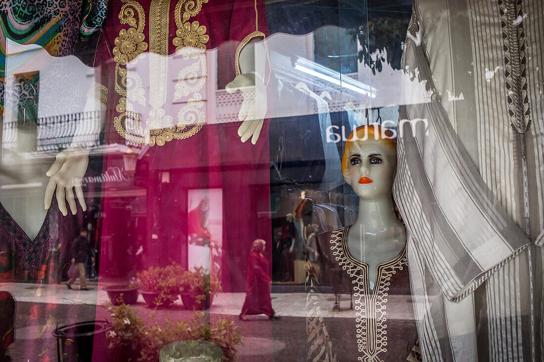 Shop of traditional clothes, reflections on a showcase, Mohamed V avenue, Tetouan. Morocco