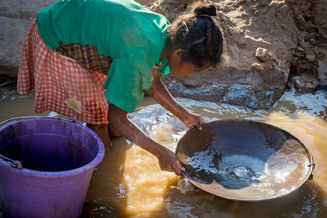 Girl miss school to pan for gold in the mountains near Ankavandra, Madagascar