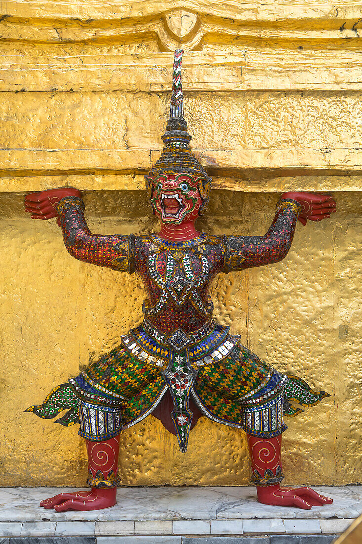 Statue of demon on a Golden Chedi, at the temple of the Emerald Buddha Wat Phra Kaeo, Grand Palace, Bangkok, Thailand