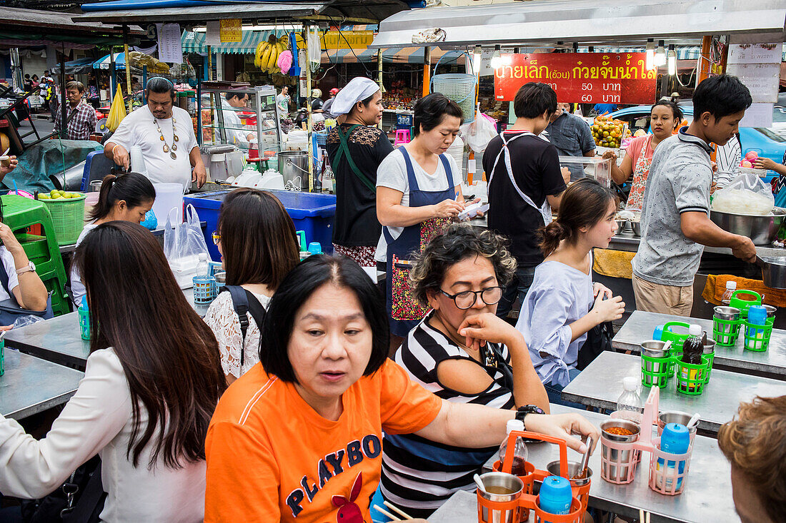 People waiting the dish order, Street food market, at Itsara nuphap, Chinatown, Bangkok, Thailand