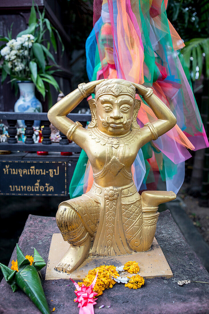 Deity and offerings, in Wat Phan Tao temple, Chiang Mai, Thailand