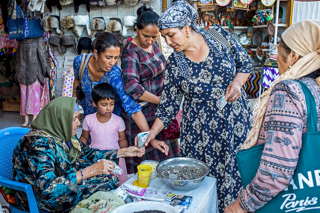 Old woman selling sunflower seeds, in Taki-Telpak Furushon bazaar, Bukhara, Uzbekistan