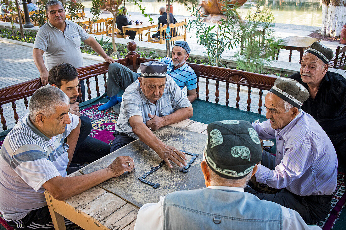 Men playing domino, chaijana, traditional tea house, in Lyabi-Hauz square, Bukhara, Uzbekistan