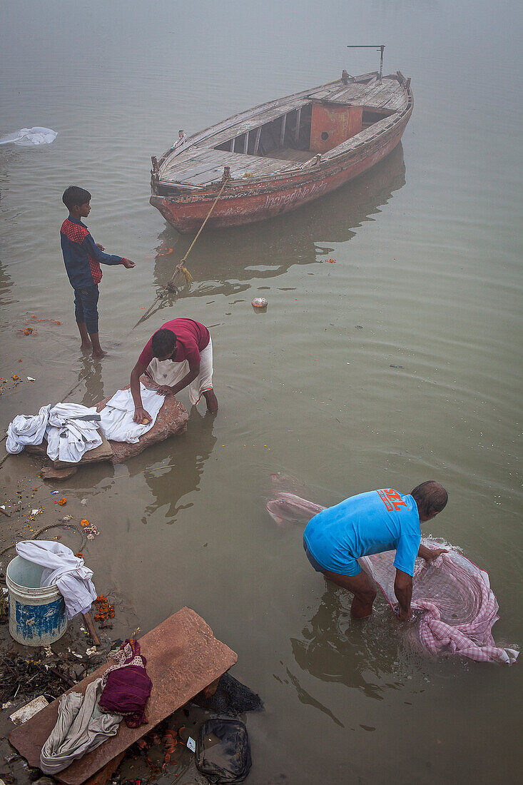 Arbeiter beim Wäschewaschen, im Ganges, Varanasi, Uttar Pradesh, Indien.