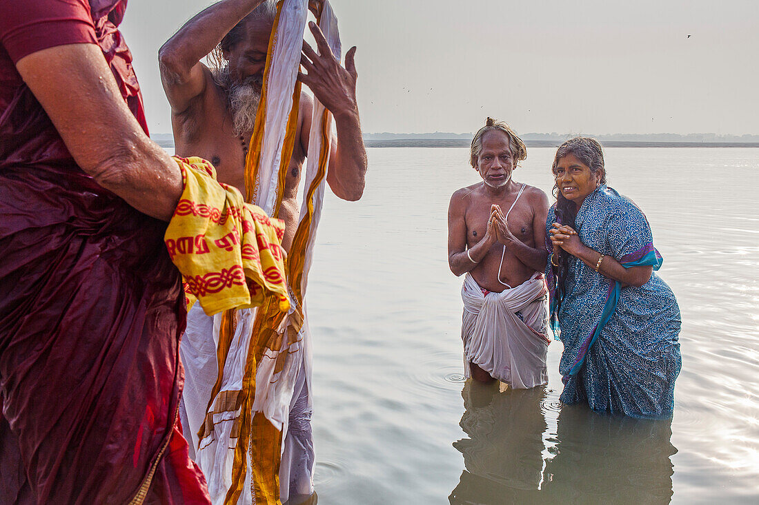 Pilgrims praying and bathing, in the ghats of Ganges river, Varanasi, Uttar Pradesh, India.