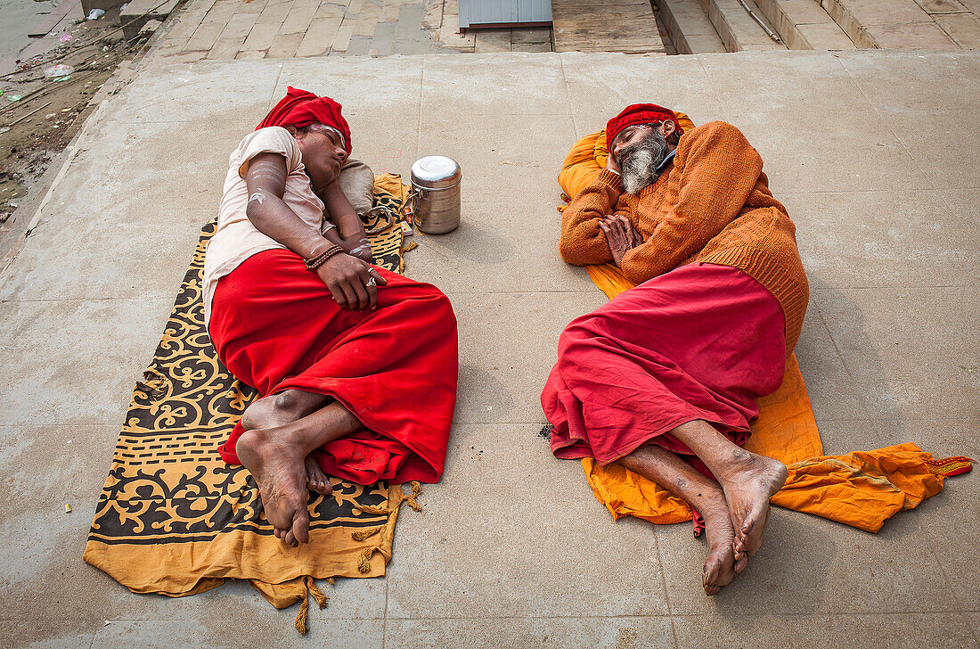 Sadhus sleeping, in the ghats of Ganges river, Varanasi, Uttar Pradesh, India.