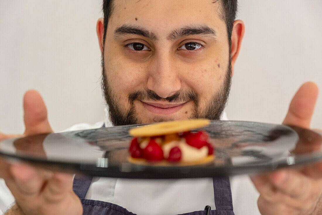 Harvey Perttola, head chef of Maribel restaurant, showing The dish duck liver with raspberries, 6 Brindley Pl, Birmingham, England