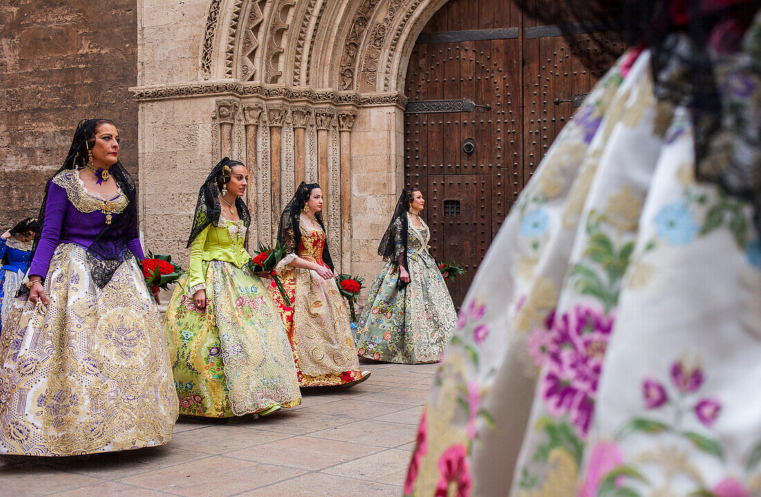 Flower offering parade,People with Floral tributes to `Virgen de los desamparados´, Fallas festival, Plaça de l´Almoina square,Valencia