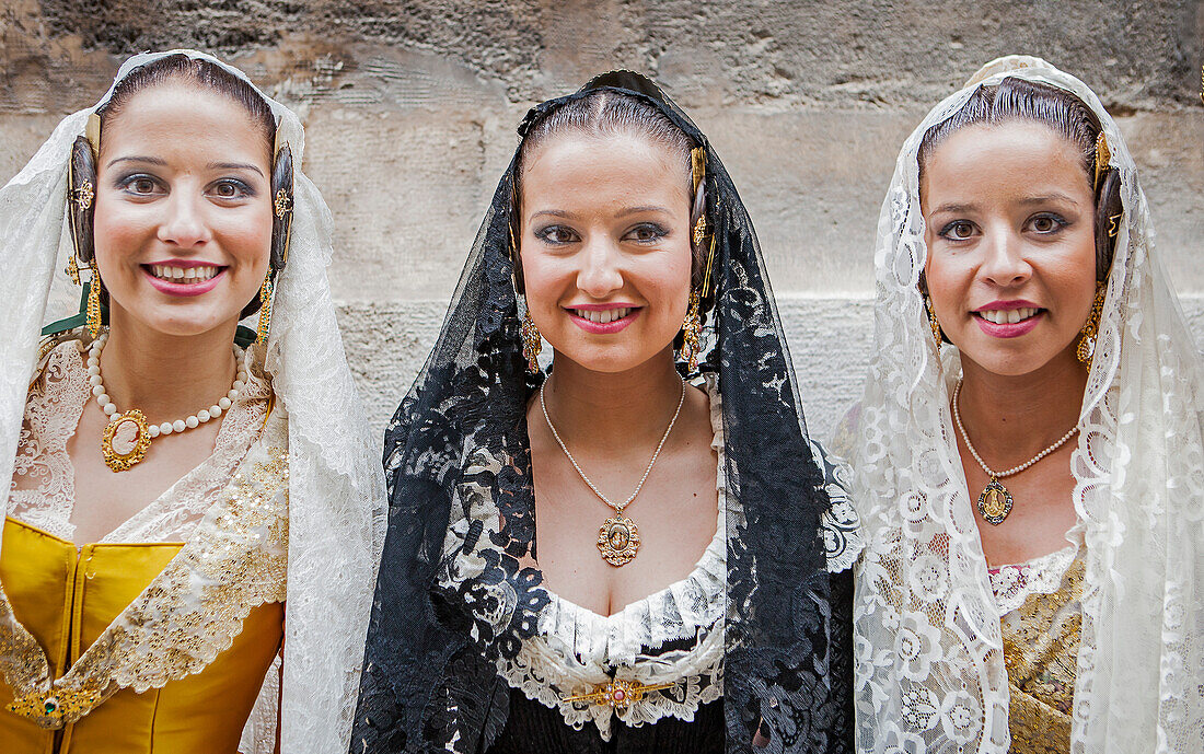 Women in Fallera Costumes during Flower offering parade, tribute to `Virgen de los desamparados´, Fallas festival, Plaza de la Virgen square,Valencia