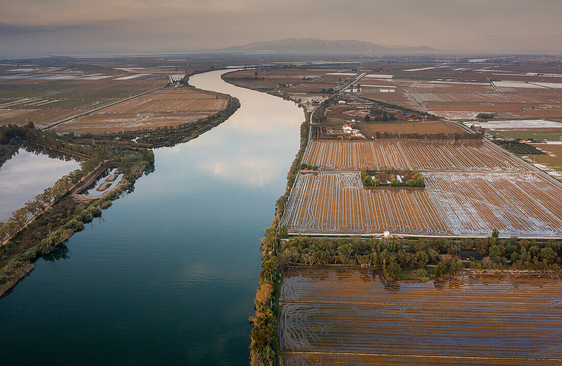 Aerial view of Ebro river and rice fields, in Ebro Delta, Natural Park, Tarragona, Spain