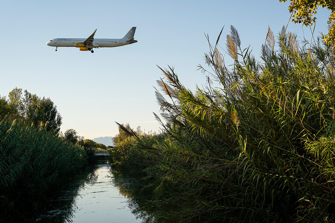 Flying over the Llobregat delta Plane heads Barcelona airport for landing. The expansion of the airport threatened with the destruction of the Llobregat delta and increased carbon emissions.Catalonia.Spain