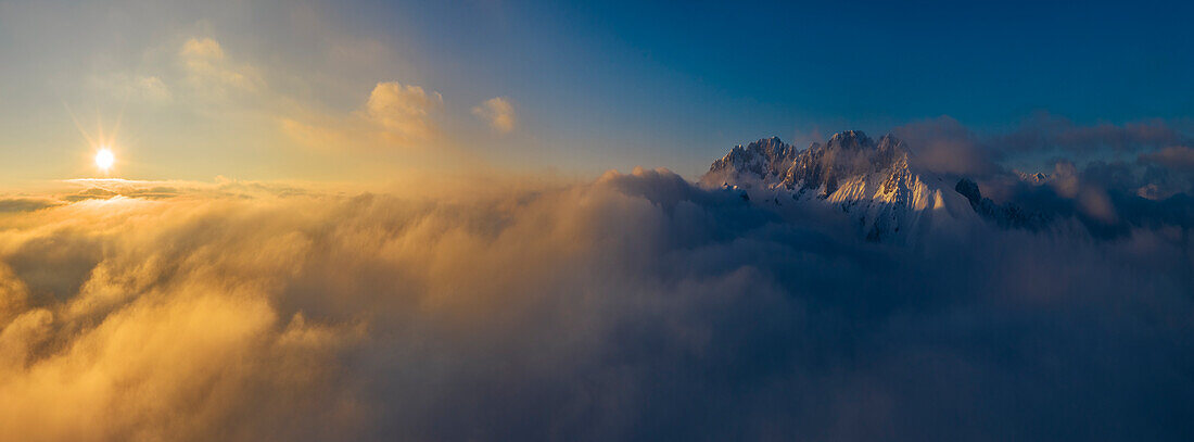 Aerial view of Presolana mountain at sunset over the clouds, Castione della Presolana, Bergamo, Lombardy, Italy, Southern Europe