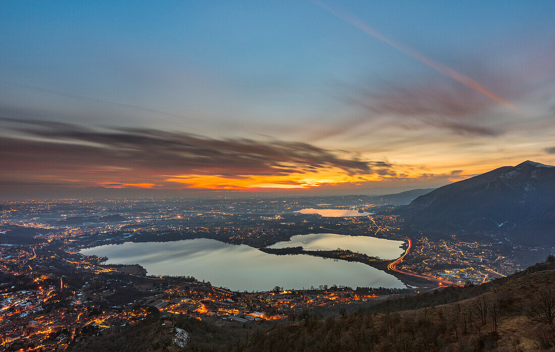 A view of illuminated cityscape from Monte Barro at sunset during summer, Monte Barro, Lecco, Lombardy, Italy, southern Europe