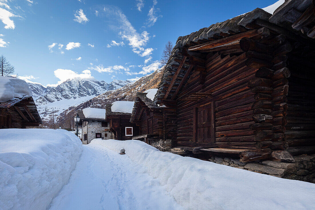 View of the old walser houses of Staffa, Macugnaga, in winter. Macugnaga, Anzasca Valley, Verbano Cusio Ossola province, Piedmont, Italy.