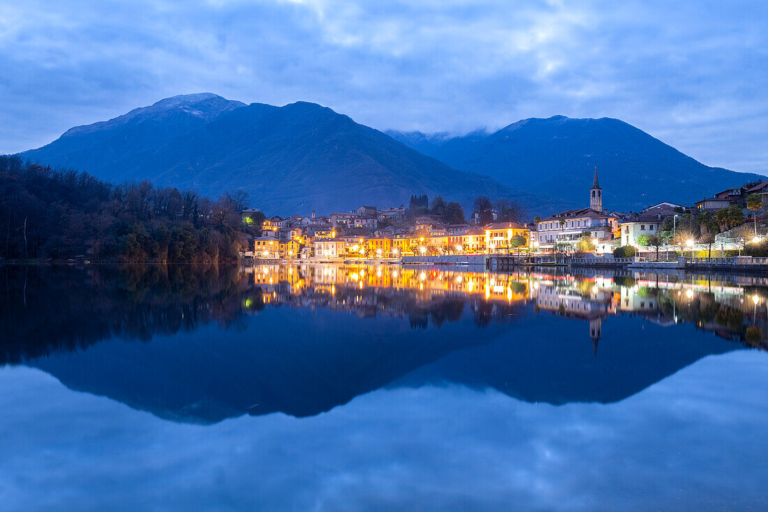 View of the small town of Mergozzo and Lake Mergozzo during blue hour. Verbano Cusio Ossola, Piedmont, Italy.