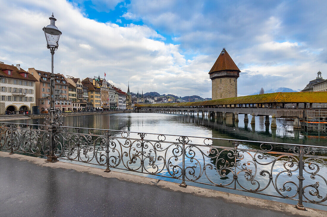 View of the Kapellbrücke bridge and the Wasserturm from the rathaussteg reflected on the Reuss river. Lucerne, canton of Lucerne, Switzerland.