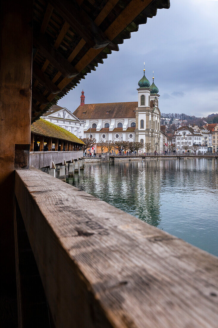 View of the Kapellbrücke bridge and the Jesuit Church reflected on the Reuss river. Lucerne, canton of Lucerne, Switzerland.