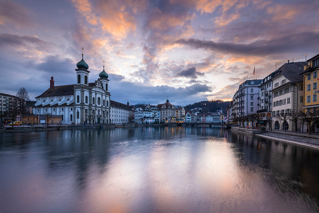 View of the Jesuit Church and the old town of Lucerne at sunset reflected on the Reuss river. Lucerne, canton of Lucerne, Switzerland.